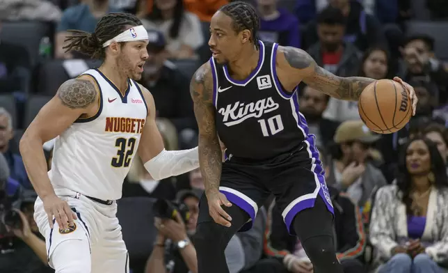 Denver Nuggets forward Aaron Gordon (32) guards Sacramento Kings forward DeMar DeRozan (10) during the first half of an NBA basketball game in Sacramento, Calif., Monday, Dec. 16, 2024. (AP Photo/Randall Benton)