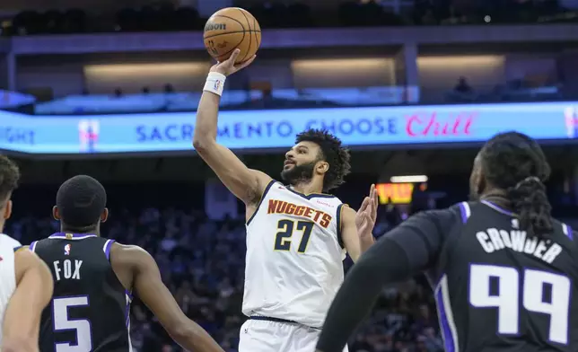 Denver Nuggets guard Jamal Murray (27) looks to shoot over Sacramento Kings guard De'Aaron Fox (5) during the first half of an NBA basketball game in Sacramento, Calif., Monday, Dec. 16, 2024. (AP Photo/Randall Benton)
