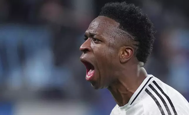 Real Madrid's Vinicius Junior celebrate after scoring during a Champions League opening phase soccer match between Atalanta and Real Madrid at the Bergamo's stadium, in Bergamo, Italy, Tuesday, Dec. 10, 2024. (Spada/LaPresse via AP)