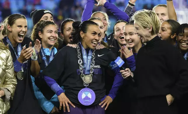 Orlando Pride forward Marta, center, is interviewed after their NWSL championship win over the Washington Spirit at CPKC Stadium, Saturday, Nov. 23, 2024, in Kansas City, Mo. (AP Photo/Reed Hoffmann, File)