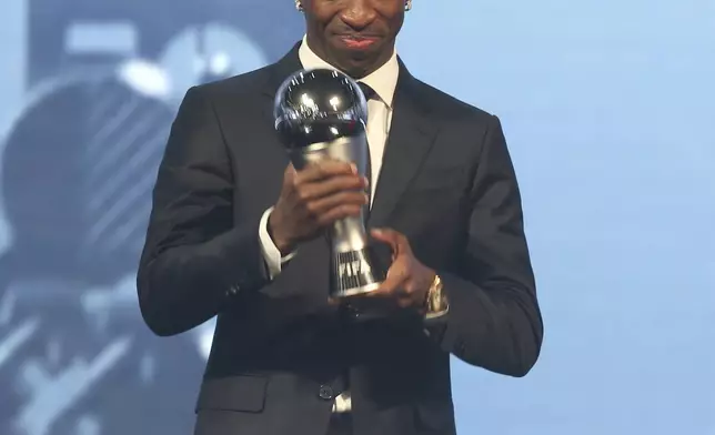 Vinicius Junior of Real Madrid is awarded as the Best Men's FIFA Player during the FIFA Football Awards 2024 in Doha, Qatar, Tuesday, Dec. 17, 2024. (AP Photo/Hussein Sayed)