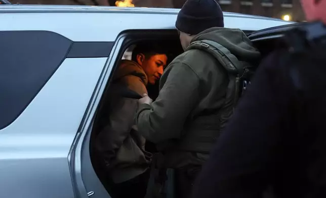 Deportation officers with Enforcement and Removal Operations in U.S. Immigration and Customs Enforcement's New York City field office arrest Wilmer Patricio Medina-Medina during an early morning operation, Tuesday, Dec. 17, 2024, in the Bronx borough of New York. (AP Photo/Julia Demaree Nikhinson)