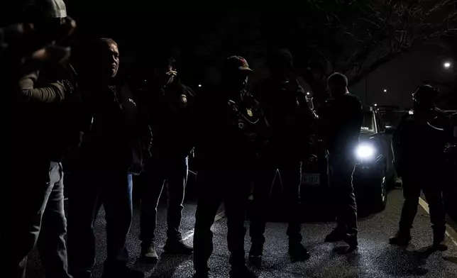 Enforcement and Removal Operations deportation officers with U.S. Immigration and Customs Enforcement's New York City field office conduct a brief before an early morning operation, Tuesday, Dec. 17, 2024, in the Bronx borough of New York. (AP Photo/Julia Demaree Nikhinson)