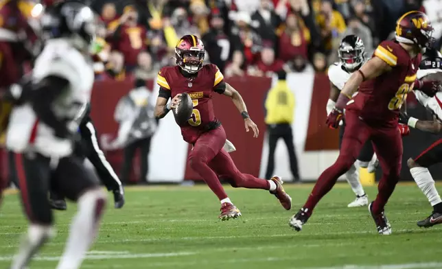 Washington Commanders quarterback Jayden Daniels (5) carries on a keeper during the second half of an NFL football game against the Atlanta Falcons, Sunday, Dec. 29, 2024, in Landover, Md. (AP Photo/Nick Wass)