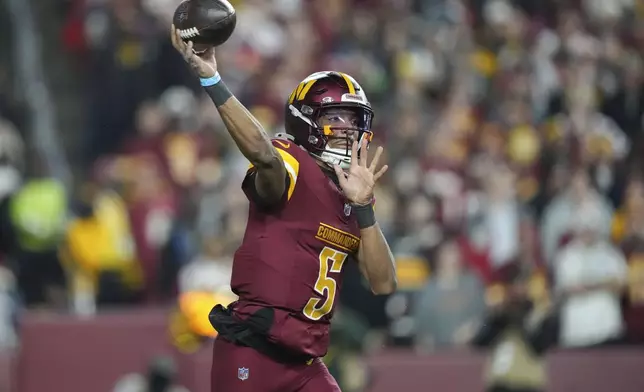 Washington Commanders quarterback Jayden Daniels (5) passes during the first half of an NFL football game against the Atlanta Falcons, Sunday, Dec. 29, 2024, in Landover. (AP Photo/Stephanie Scarbrough)