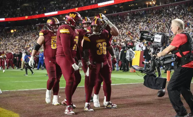 ]Washington Commanders running back Chris Rodriguez Jr. (36) celebrates his touchdown during the second half of an NFL football game against the Atlanta Falcons, Sunday, Dec. 29, 2024, in Landover, Md. (AP Photo/Nick Wass)