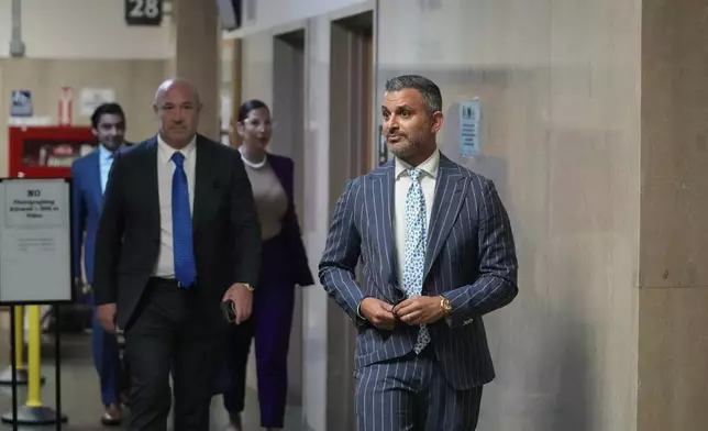 Defense attorney Saam Zangeneh, right, walks out of the courtroom at the Hall of Justice for the murder trial of Nima Momeni, Tuesday, Dec. 3, 2024, in San Francisco. (AP Photo/Godofredo A. Vásquez)