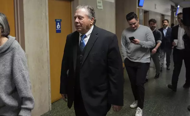 Rick Lee, center, father of Cash App founder Bob Lee, walks to Department 28 to enter the courtroom at the Hall of Justice for the murder trial of Nima Momeni, Tuesday, Dec. 3, 2024, in San Francisco. (AP Photo/Godofredo A. Vásquez)