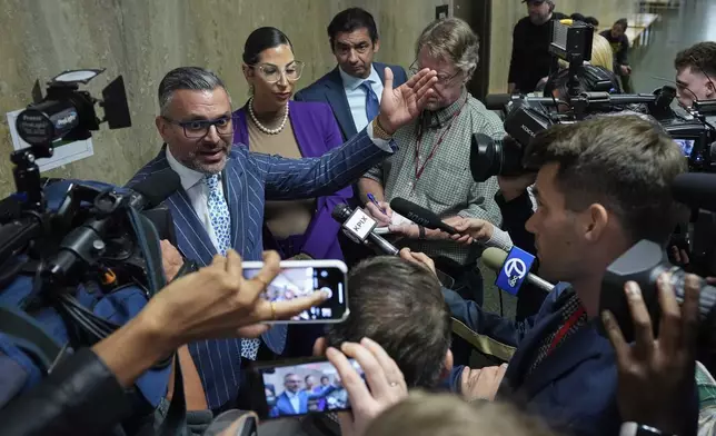 Defense attorney Saam Zangeneh, top left, speaks to reporters after exiting the courtroom at the Hall of Justice for the murder trial of Nima Momeni, Tuesday, Dec. 3, 2024, in San Francisco. (AP Photo/Godofredo A. Vásquez)