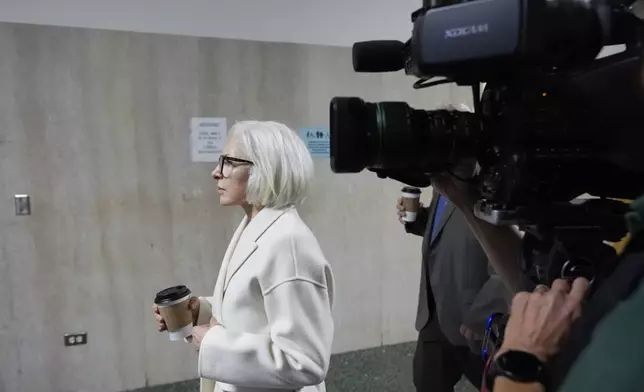 Mahnaz Tayarani, left, mother of Nima Momeni – who is charged with murder in Cash App founder Bob Lee's stabbing death – walks to Department 28 to enter the courtroom at the Hall of Justice for Momeni's murder trial Tuesday, Dec. 3, 2024, in San Francisco. (AP Photo/Godofredo A. Vásquez)