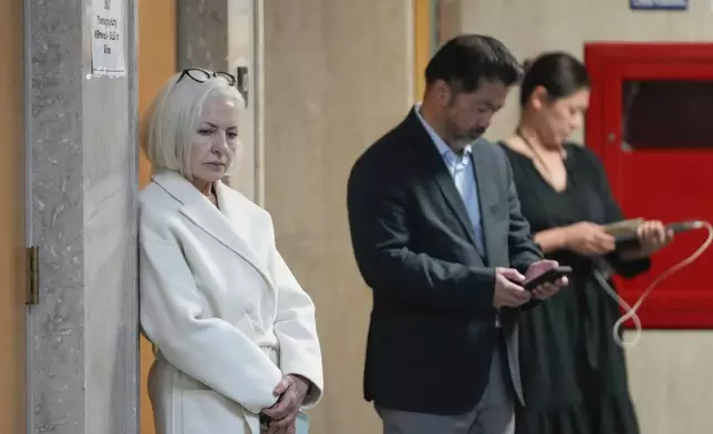 Mahnaz Tayarani, left, mother of Nima Momeni – who is charged with murder in Cash App founder Bob Lee's stabbing death – waits to enter the courtroom at the Hall of Justice for Momeni's murder trial Tuesday, Dec. 3, 2024, in San Francisco. (AP Photo/Godofredo A. Vásquez)