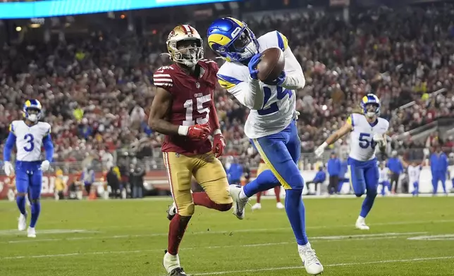 Los Angeles Rams cornerback Darious Williams (24) intercepts a pass in front of San Francisco 49ers wide receiver Jauan Jennings (15) during the second half of an NFL football game in Santa Clara, Calif., Thursday, Dec. 12, 2024. (AP Photo/Godofredo A. Vásquez)
