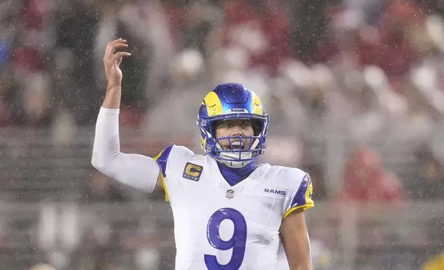 Rain falls as Los Angeles Rams quarterback Matthew Stafford signals at the line of scrimmage during the first half of an NFL football game against the San Francisco 49ers in Santa Clara, Calif., Thursday, Dec. 12, 2024. (AP Photo/Godofredo A. Vásquez)