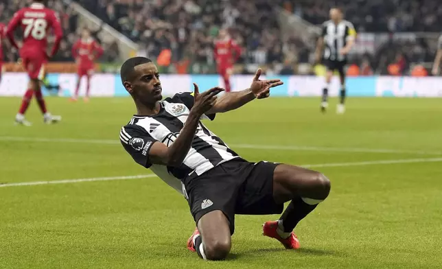 Newcastle United's Alexander Isak celebrates scoring their side's first goal of the game against Liverpool during a Premier League soccer match at St. James' Park, Wednesday, Dec. 4, 2024, in Newcasatle, England. (Owen Humphreys/PA via AP)