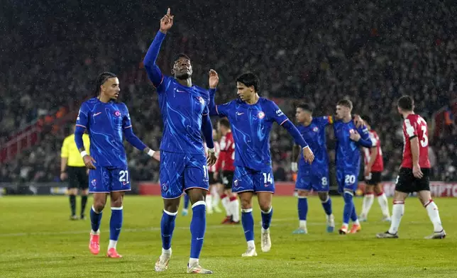 Chelsea's Noni Madueke celebrates scoring their side's third goal of the game during the Premier League soccer match between Southampton and Chelsea at St Mary's Stadium, Southampton, England, Wednesday Dec. 4, 2024. (Andrew Matthews/PA via AP)