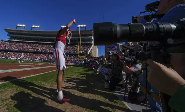 Oklahoma wide receiver Zion Kearney celebrates in front of photographers after scoring a touchdown on a pass from quarterback Michael Hawkins Jr. during the first half of the Armed Forces Bowl NCAA college football game against Navy, Friday, Dec. 27, 2024, in Fort Worth, Texas. (AP Photo/Julio Cortez)