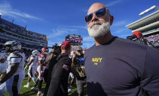 Navy head coach Brian Newberry walks on the field after shaking hands with Oklahoma head coach Brent Venables following the Armed Forces Bowl NCAA college football game, Friday, Dec. 27, 2024, in Fort Worth, Texas. Navy won 21-20. (AP Photo/Julio Cortez)