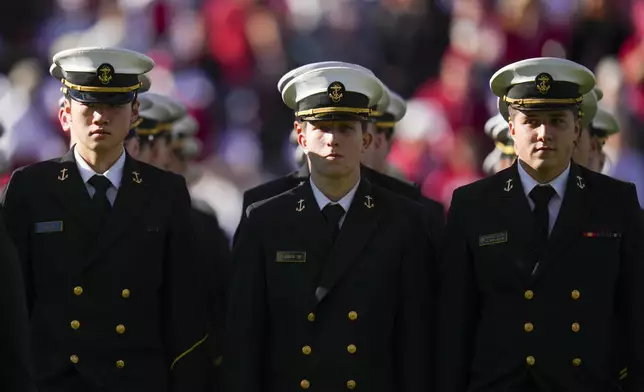 U.S. Navy Midshipmen march on the field prior to the Armed Forces Bowl NCAA college football game between Navy and Oklahoma, Friday, Dec. 27, 2024, in Fort Worth, Texas. (AP Photo/Julio Cortez)