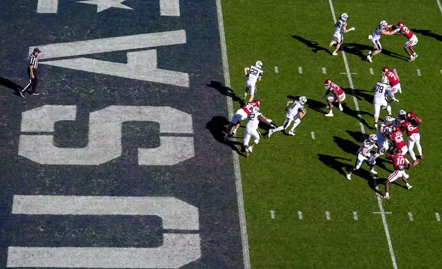 Navy quarterback Blake Horvath, center, runs with the ball on his way to a 95-yard touchdown run during the second half of the Armed Forces Bowl NCAA college football game against Oklahoma, Friday, Dec. 27, 2024, in Fort Worth, Texas. Navy won 21-20. (AP Photo/Julio Cortez)