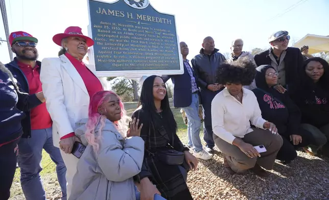 Family members celebrate the legacy of James Meredith who became the first Black student to enroll at the University of Mississippi in 1962, following the unveiling of a Mississippi Department of Archives and History marker recognizing his birthplace in Kosciusko, Miss., Friday, Dec. 20, 2024. (AP Photo/Rogelio V. Solis)