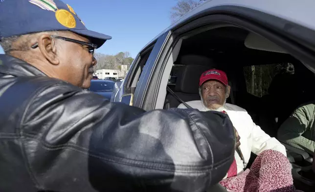 George Smith, left, congratulates James Meredith, who became the first Black student to enroll at the University of Mississippi in 1962, on being honored with a Mississippi Department of Archives and History marker recognizing his birthplace and his legacy in the Civil Rights Movement, Friday, Dec. 20, 2024, in Kosciusko, Miss.(AP Photo/Rogelio V. Solis)