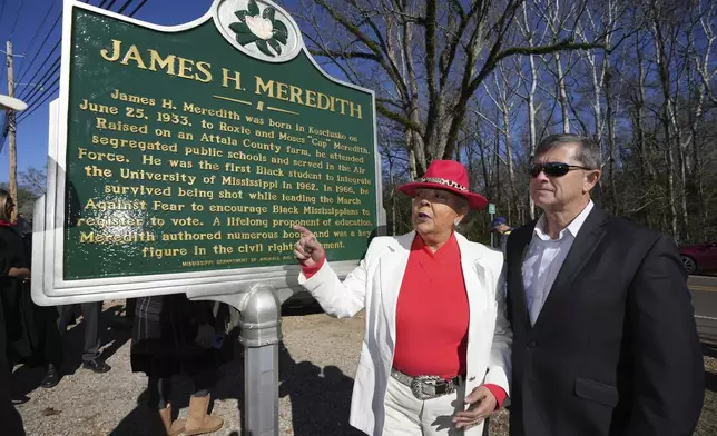 Judy Alsobrooks Meredith, wife of James Meredith, who became the first Black student to enroll at the University of Mississippi in 1962, left, and Kosciusko Mayor Tim Kyle, review the Mississippi Department of Archives and History marker recognizing Meredith's birthplace and his legacy in Kosciusko, Miss., Friday, Dec. 20, 2024. (AP Photo/Rogelio V. Solis)