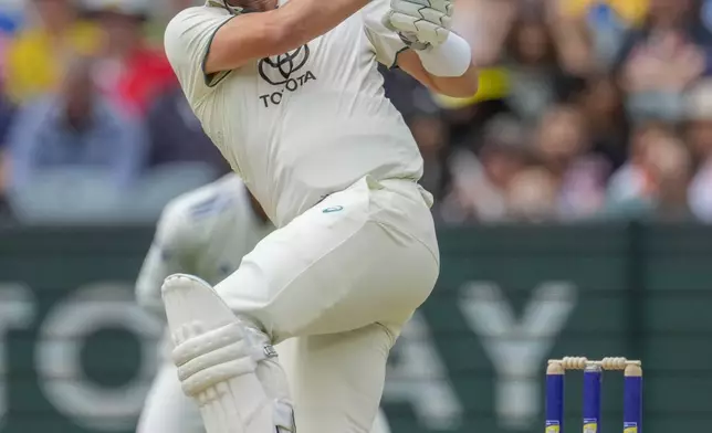 Australia's captain Pat Cummins plays a shot during play on the second day of the fourth cricket test between Australia and India at the Melbourne Cricket Ground, Melbourne, Australia, Friday, Dec. 27, 2024. (AP Photo/Asanka Brendon Ratnayake)