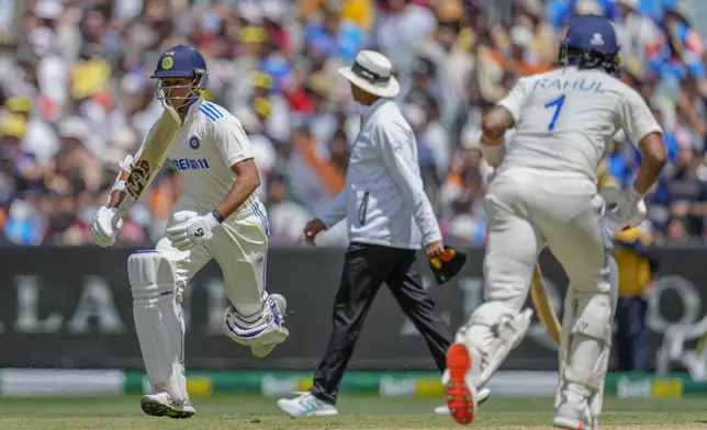 India's Yashasvi Jaiswal, left, and KL Rahul run between the wickets to score during play on the second day of the fourth cricket test between Australia and India at the Melbourne Cricket Ground, Melbourne, Australia, Friday, Dec. 27, 2024. (AP Photo/Asanka Brendon Ratnayake)