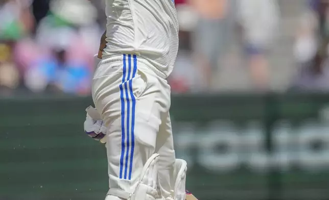 India's KL Rahul reacts after being hit on a gloves during play on the second day of the fourth cricket test between Australia and India at the Melbourne Cricket Ground, Melbourne, Australia, Friday, Dec. 27, 2024. (AP Photo/Asanka Brendon Ratnayake)