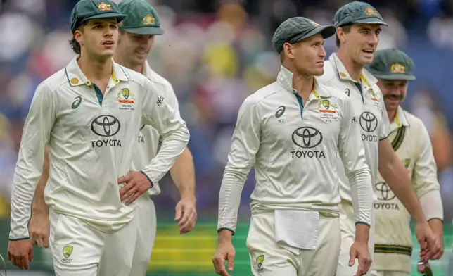 Australian players walk off the field on the end of play of the second day of the fourth cricket test between Australia and India at the Melbourne Cricket Ground, Melbourne, Australia, Friday, Dec. 27, 2024. (AP Photo/Asanka Brendon Ratnayake)