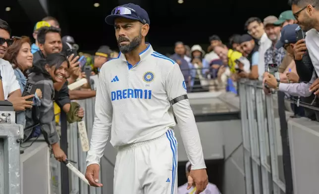 India's Virat Kohli walks out before the start of play on the second day of the fourth cricket test between Australia and India at the Melbourne Cricket Ground, Melbourne, Australia, Friday, Dec. 27, 2024. (AP Photo/Asanka Brendon Ratnayake)