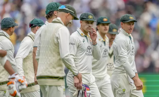 Australian players walk off the field on the end of play of the second day of the fourth cricket test between Australia and India at the Melbourne Cricket Ground, Melbourne, Australia, Friday, Dec. 27, 2024. (AP Photo/Asanka Brendon Ratnayake)