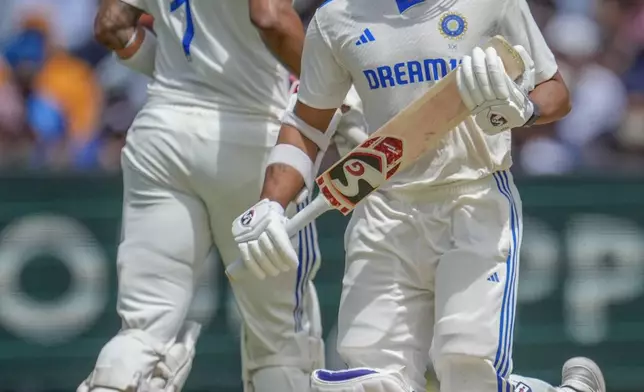 India's Yashasvi Jaiswal, right, and KL Rahul run between the wickets to score during play on the second day of the fourth cricket test between Australia and India at the Melbourne Cricket Ground, Melbourne, Australia, Friday, Dec. 27, 2024. (AP Photo/Asanka Brendon Ratnayake)