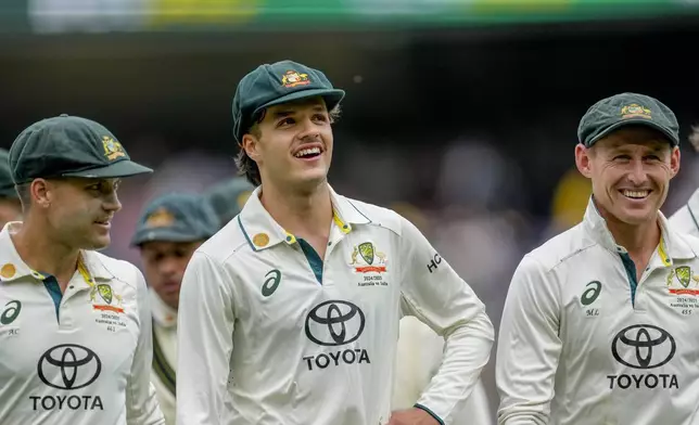 Australia's Alex Carey, left, Sam Konstas, center, and Marnus Labuschagne walk off the field on the end of play of the second day of the fourth cricket test between Australia and India at the Melbourne Cricket Ground, Melbourne, Australia, Friday, Dec. 27, 2024. (AP Photo/Asanka Brendon Ratnayake)