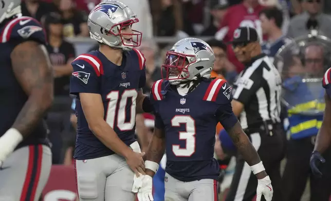 New England Patriots wide receiver DeMario Douglas (3) celebrates his touchdown with quarterback Drake Maye (10) during the second half of an NFL football game against the Arizona Cardinals, Sunday, Dec. 15, 2024, in Glendale, Ariz. (AP Photo/Rick Scuteri)