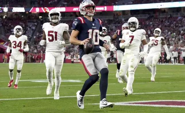 New England Patriots quarterback Drake Maye (10) runs for a touchdown against the Arizona Cardinals during the second half of an NFL football game, Sunday, Dec. 15, 2024, in Glendale, Ariz. (AP Photo/Rick Scuteri)