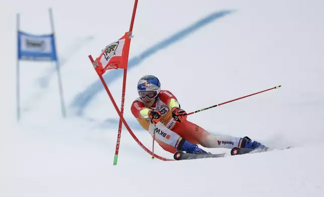 Switzerland's Marco Odermatt speeds down the course during an alpine ski, men's World Cup giant slalom, in Alta Badia, Italy, Sunday, Dec. 22, 2024. (AP Photo/Gabriele Facciotti)