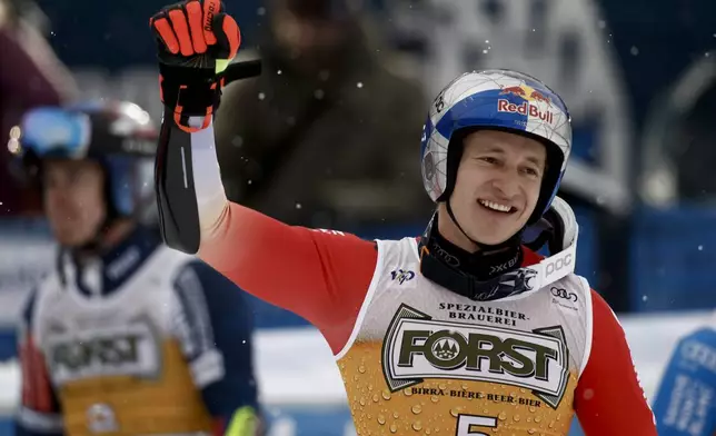 Switzerland's Marco Odermatt celebrates at the finish area of an alpine ski, men's World Cup giant slalom, in Alta Badia, Italy, Sunday, Dec. 22, 2024. (AP Photo/Gabriele Facciotti)