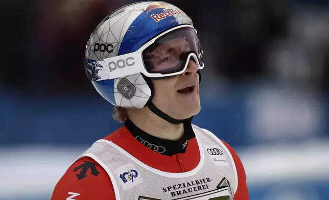 Switzerland's Marco Odermatt checks his time at the finish area of an alpine ski, men's World Cup giant slalom, in Alta Badia, Italy, Sunday, Dec. 22, 2024. (AP Photo/Gabriele Facciotti)