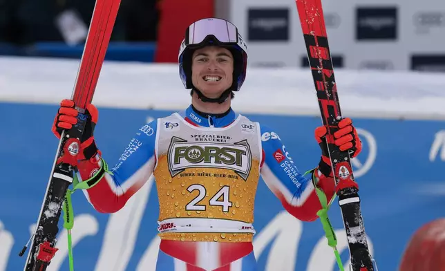 France's Leo Anguenot celebrates at the finish area of an alpine ski, men's World Cup giant slalom, in Alta Badia, Italy, Sunday, Dec. 22, 2024. (AP Photo/Alessandro Trovati)