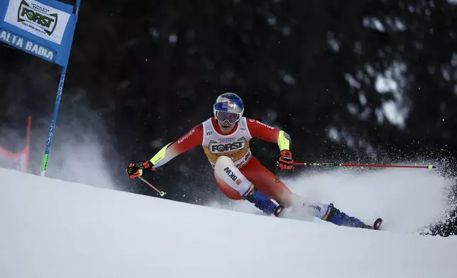 Switzerland's Marco Odermatt speeds down the course during an alpine ski, men's World Cup giant slalom, in Alta Badia, Italy, Sunday, Dec. 22, 2024. (AP Photo/Gabriele Facciotti)