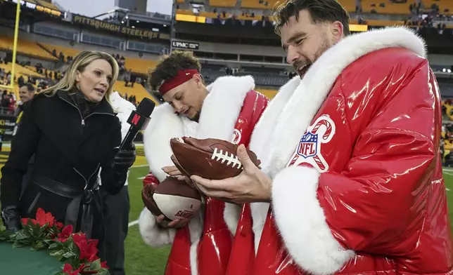 Kansas City Chiefs quarterback Patrick Mahomes and Travis Kelce speak after an NFL football game against the Pittsburgh Steelers, Wednesday, Dec. 25, 2024, in Pittsburgh. (AP Photo/Matt Freed)