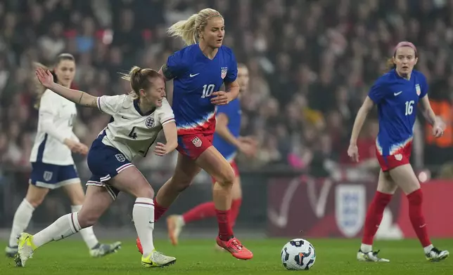 England's Keira Walsh, centre left, and United States' Lindsey Horan challenge for the ball during the International friendly women soccer match between England and United States at Wembley stadium in London, Saturday, Nov. 30, 2024. (AP Photo/Kirsty Wigglesworth)