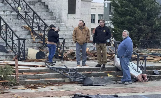 People view damage from a storm through that rolled through the night before is seen at the heart of downtown on Sunday, Dec. 29, 2024, in Athens, Ala. (AP Photo/Lance George)