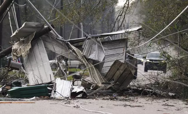 Debris block a portion of Porter Lane after strong thunderstorms pass through the Greater Houston region, Saturday, Dec. 28, 2024, in Porter Heights. (Jason Fochtman/Houston Chronicle via AP)