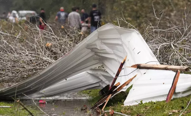 Sheet metal from a nearby home is seen after strong thunderstorms pass through the Greater Houston region, Saturday, Dec. 28, 2024, in Porter Heights. (Jason Fochtman/Houston Chronicle via AP)