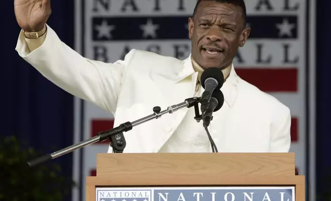 FILE - Rickey Henderson waves to the crowd during his induction speech at the Baseball Hall of Fame in Cooperstown, N.Y., July 26, 2009. (AP Photo/Mike Groll, File)