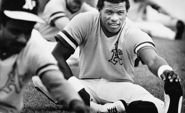 FILE - Rickey Henderson, the Oakland Athletics record-setting base stealer, stretches during his first workout at Oakland's Phoenix spring training camp Feb. 27, 1983. (AP Photo/Sal Veder, File)