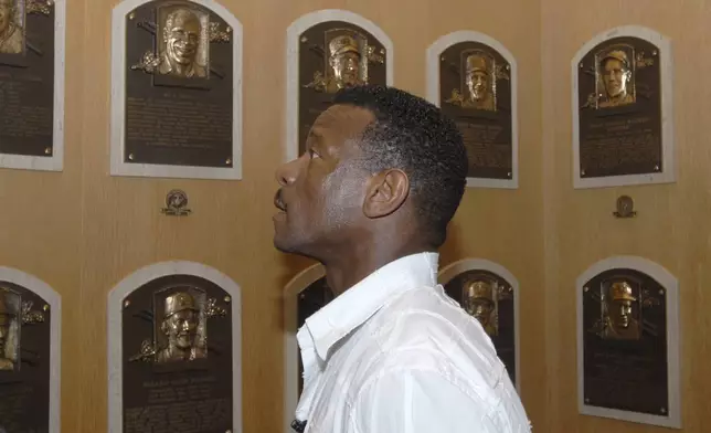 FILE - Class of 2009 Baseball Hall of Fame inductee Rickey Henderson views plaques on a tour of the National Baseball Hall of Fame and Museum in Cooperstown, N.Y., May 8, 2009. (AP Photo/Tim Roske, File)