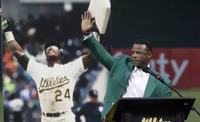 FILE - Former baseball player Rickey Henderson waves after speaking during a ceremony inducting him into the Oakland Athletics' Hall of Fame before a baseball game between the Athletics and the New York Yankees in Oakland, Calif., Sept. 5, 2018. (AP Photo/Jeff Chiu, File)